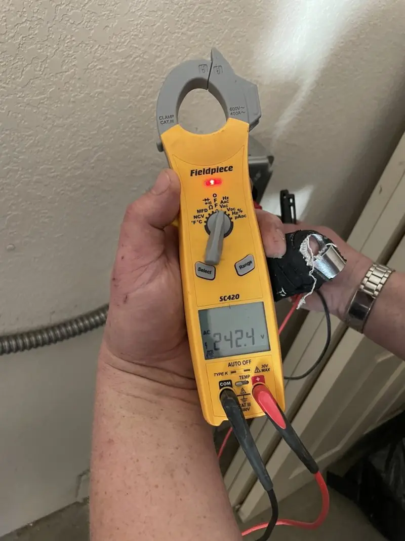Voltage testing with clamp meter during Whole House Surge Protector in Sanbornton